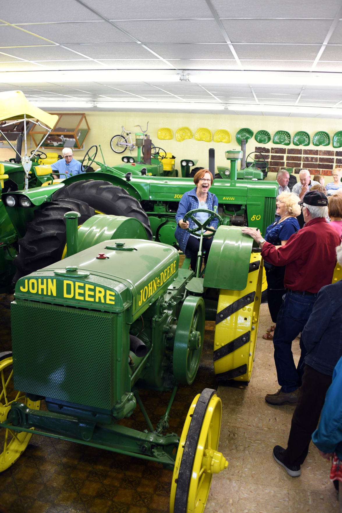 017 Marie Brown with a 1925 John Deere D at Galen Furstenau's John Deere Museum in Neligh.JPG